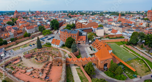 Toruń, ruiny zamku krzyżackiego i stare miasto w tle photo