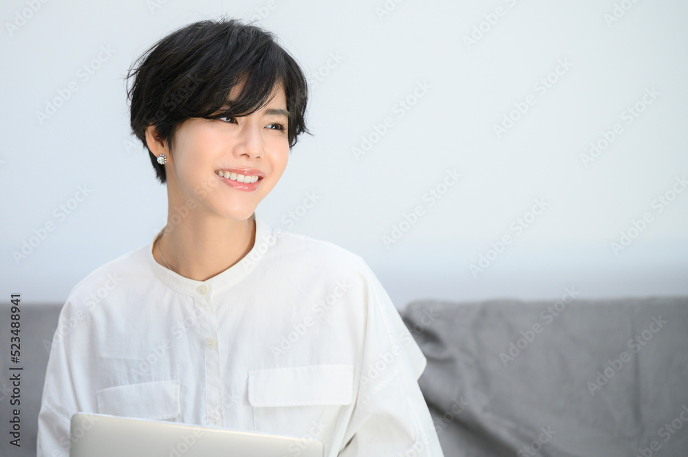 Woman relaxing on sofa while using computer Woman relaxing on sofa while using computer