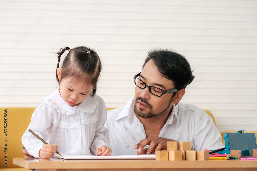 Father and daughter spend time on weekends playing together. Father and daughter spend time on weekends playing together.