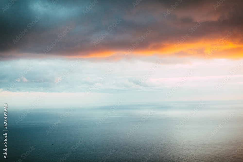 Amazing beautiful sunset over the ocean, clouds, pastel colors, blue, pink.
