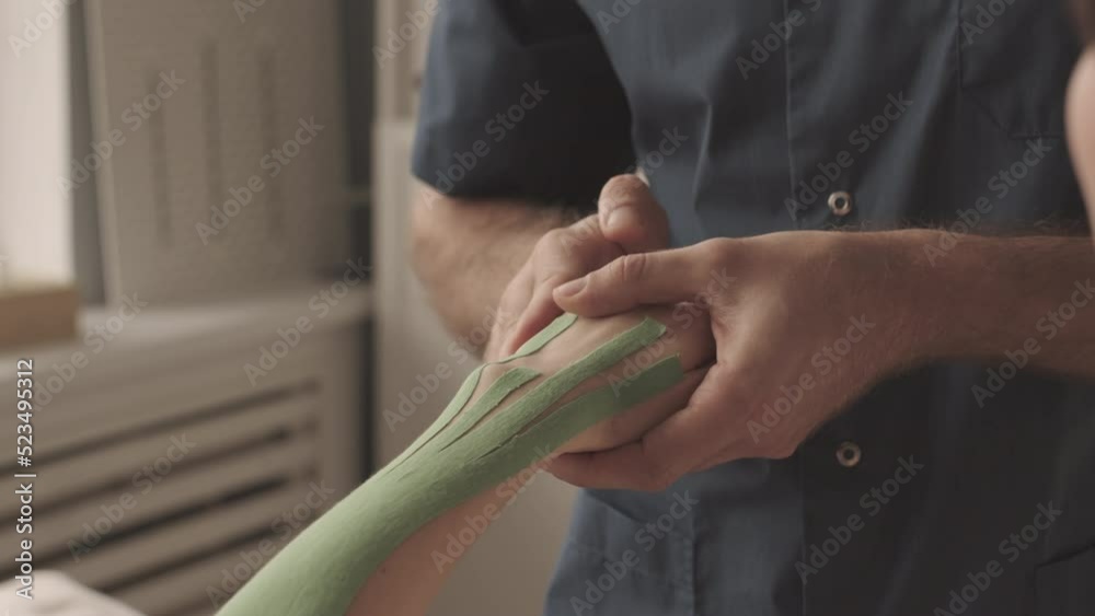 Slowmo of unrecognizable male physical therapist specializing on