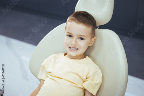 Cute little boy getting teeth exam at dental clinic. Child visit dentist. Cute boy in dental clinic. Child in stomatological cabinet with dentists. Happy child in dentist chair.
