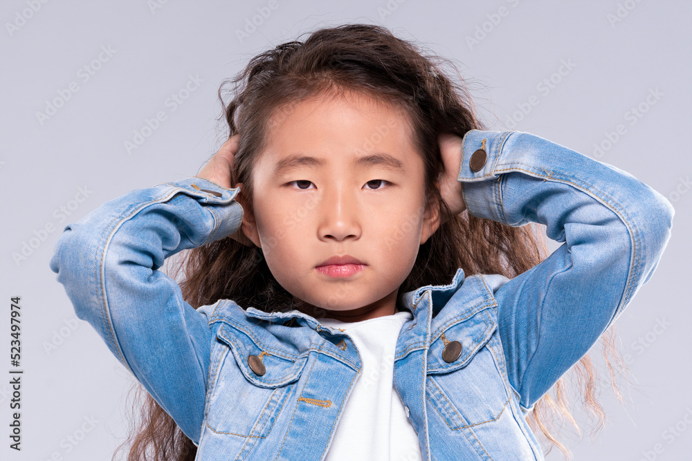 Sad girl child holding hands on the head. He has a headache Sad girl child holding hands on the head. He has a headache