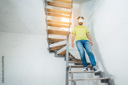 Wallpaper Mural Young bearded man using virtual reality goggles before starting renovations in his townhouse Torontodigital.ca