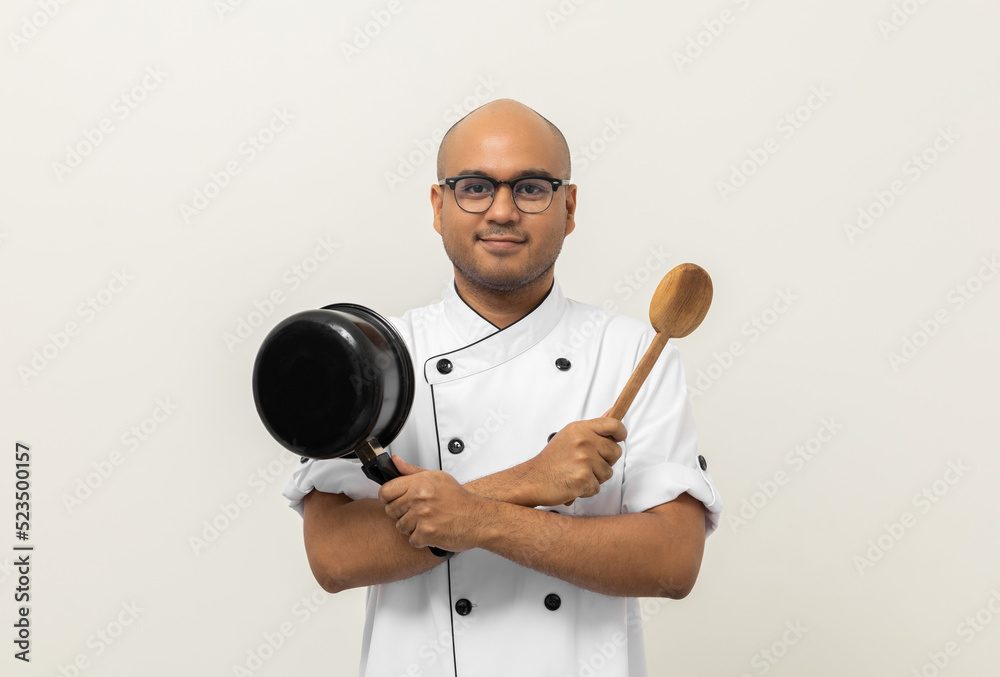 Young handsome asian man chef in uniform holding ladle and pot utensils cooking in the kitchen various gesture action on isolated background. Indian man Occupation chef restaurant and hotel. Young handsome asian man chef in uniform holding ladle and pot utensils cooking in the kitchen various gesture action on isolated background. Indian man Occupation chef restaurant and hotel.