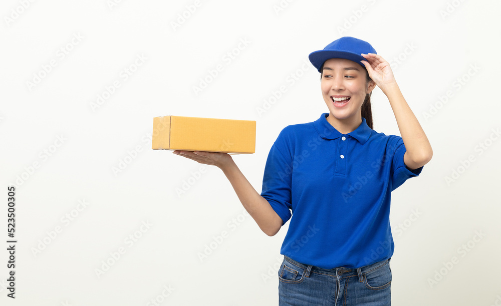 Happy delivery asian woman in blue uniform standing holding parcel cardboard box on isolated white background. Smiling female delivery sending box package service worker. Happy delivery asian woman in blue uniform standing holding parcel cardboard box on isolated white background. Smiling female delivery sending box package service worker.
