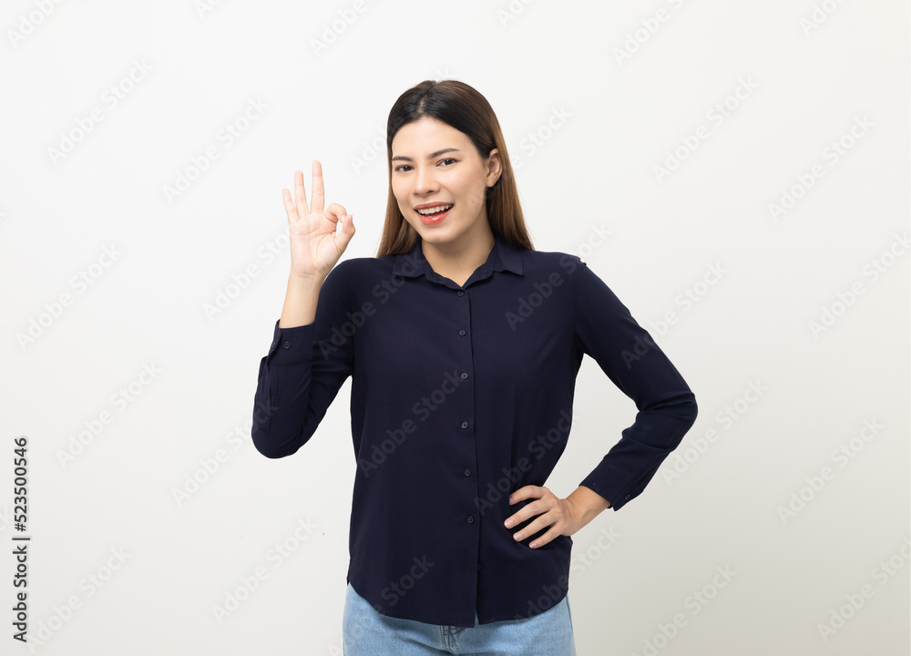 Portrait of Young beautiful mixed race woman standing and smiling isolated on white background showing ok sign. Attractive female feeling surprised and happy. Portrait of Young beautiful mixed race woman standing and smiling isolated on white background showing ok sign. Attractive female feeling surprised and happy.