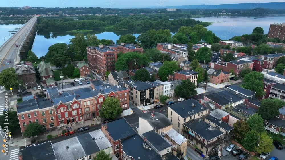 Riverfront homes and business buildings along Susquehanna River in downtown Harrisburg PA Pennsylvania. Aerial shot.