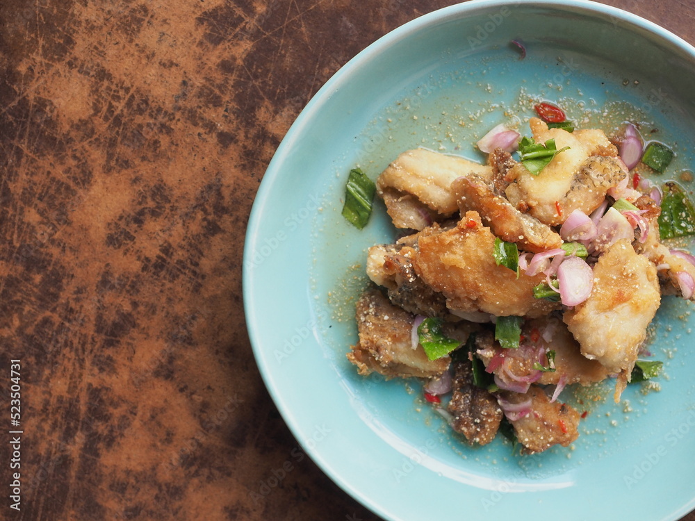 top view dish of Thai Larb with fried fish on wood background top view dish of Thai Larb with fried fish on wood background