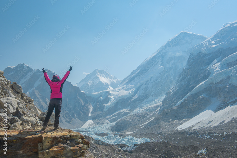 Female backpacker enjoying the view on mountain walk in Himalayas. Everest Base Camp trail route, Nepal trekking, Himalaya tourism