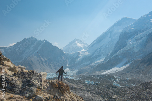 Male backpacker enjoying the view on mountain walk in Himalayas. Everest Base Camp trail route  Nepal trekking  Himalaya tourism.