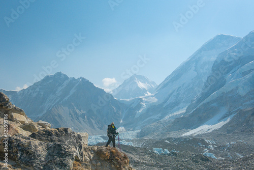 Male backpacker enjoying the view on mountain walk in Himalayas. Everest Base Camp trail route, Nepal trekking, Himalaya tourism. © CravenA