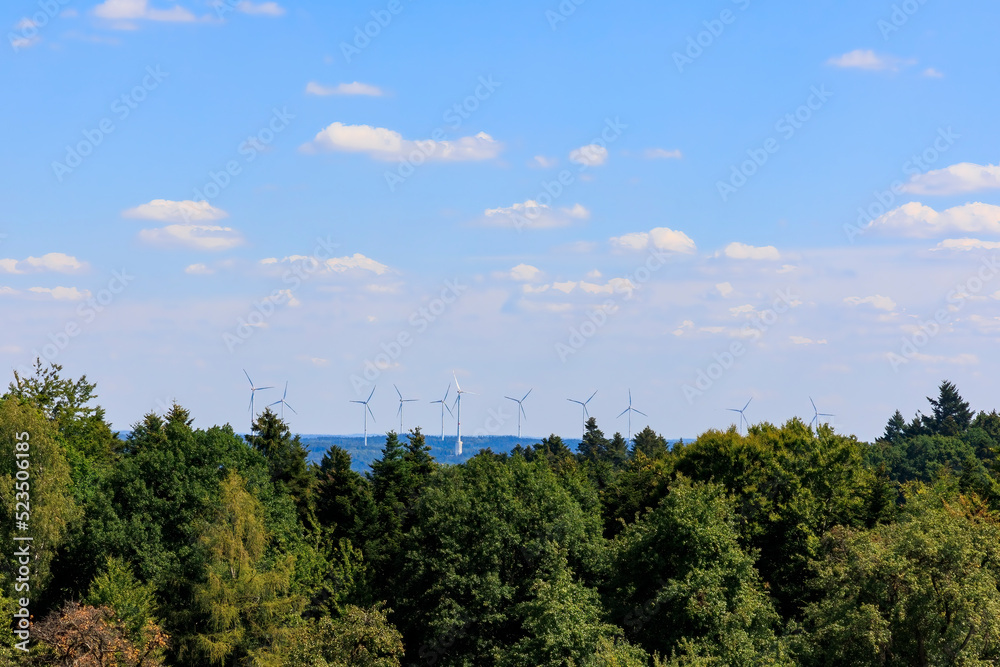 Obraz premium View over the forests in Rems-Murr district near Geildorf on the Swabian Alb in Germany to a wind farm with wind turbines
