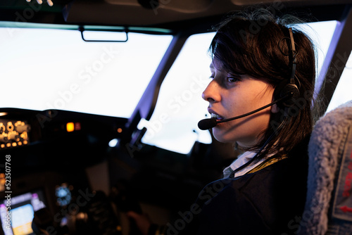 Aircrew copilot using power radar on dashboard to fly aircraft jet, pushing control panel lever and navigation command in cockpit cabin. Flying airplane with dashboard buttons and handle.
