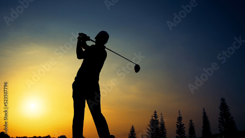 Silhouette Golfing player T-OFF hitting driver shot par3 for hole in one tournament golf course,  sports relax in holidays summer vacation