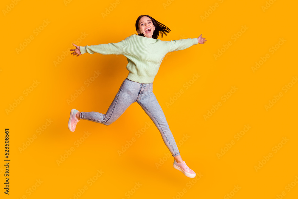 Full body photo of young pretty woman have fun jump up spring travel isolated over yellow color background