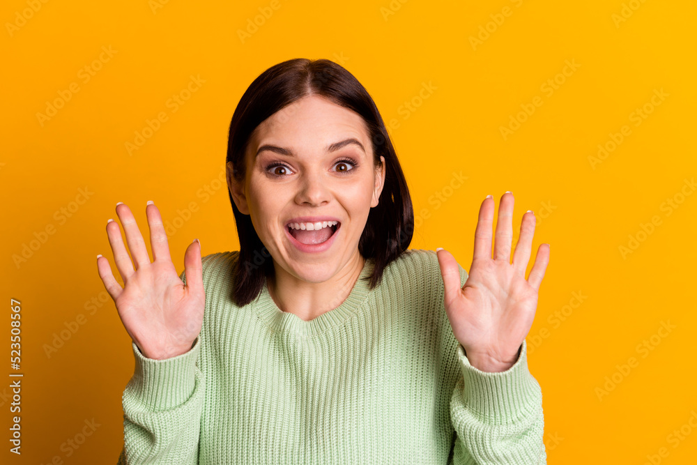 Photo of young excited girl waving hand hello greeting symbol friendly isolated over yellow color background Photo of young excited girl waving hand hello greeting symbol friendly isolated over yellow color background