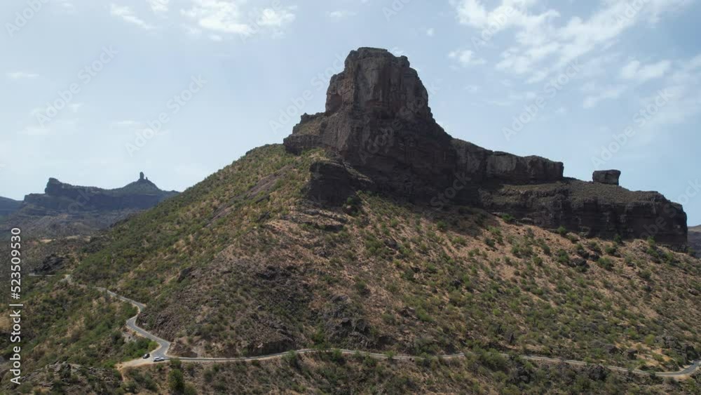 fantastic aerial shot in orbit of the Roque Bentayga, seeing the Roque Nublo on the horizon. Take on a sunny day on the Island of Gran Canaria. fantastic aerial shot in orbit of the Roque Bentayga, seeing the Roque Nublo on the horizon. Take on a sunny day on the Island of Gran Canaria.