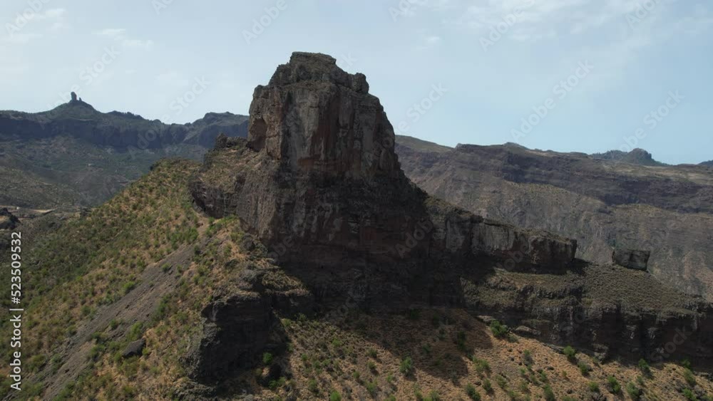 aerial shot in approach to the Roque Bentayga, seeing the Roque Nublo on the horizon. Take on a sunny day on the Island of Gran Canaria. aerial shot in approach to the Roque Bentayga, seeing the Roque Nublo on the horizon. Take on a sunny day on the Island of Gran Canaria.
