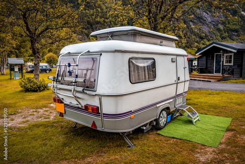 Camping trailer stands in campsite