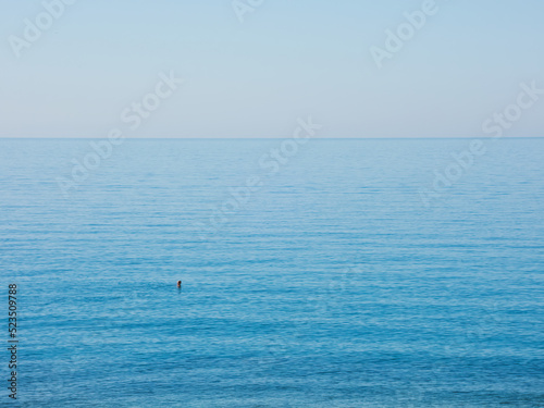 Man swimming in the mediterranean sea on a quiet sunny day © RISHAD