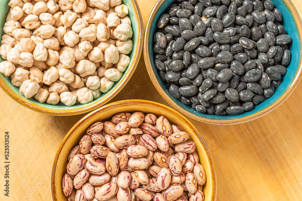 Fototapeta premium Dried Legumes In Bowls On Wooden Cutting Board.
