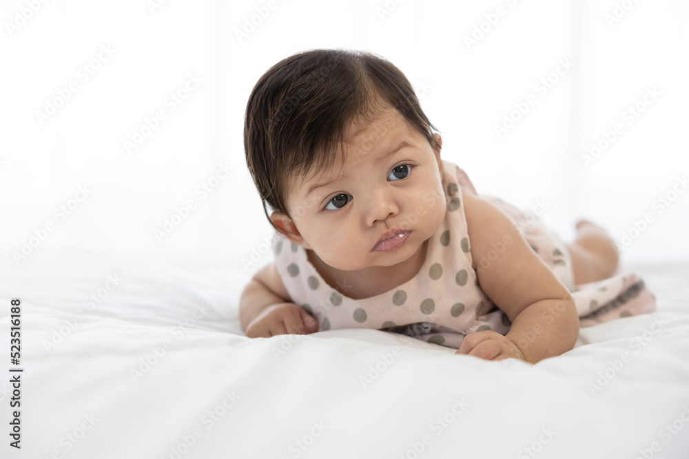 portrait cute baby crawling on bed and looking to something portrait cute baby crawling on bed and looking to something