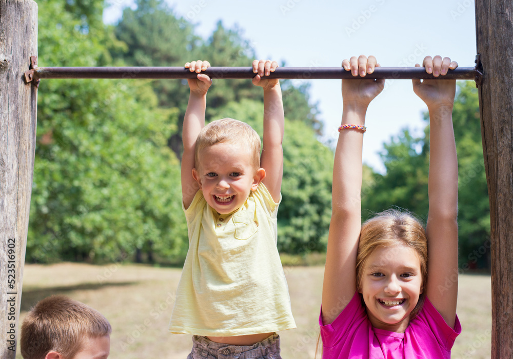 Fototapeta premium Children playing on the playground on a sunny summer day