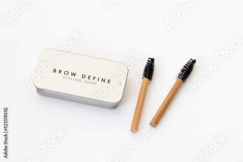 Two bamboo brow brushes and brow styling soap in a metal box. Cosmetic set