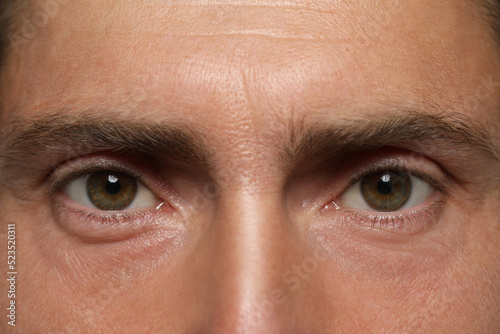 Man with beautiful hazel eyes as background, closeup