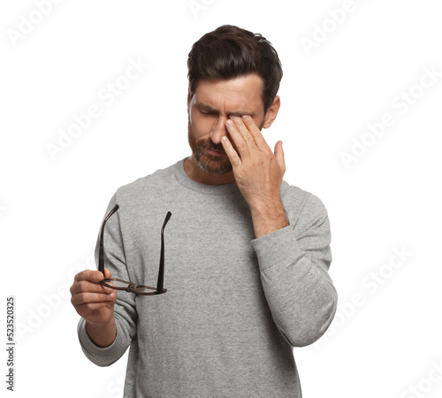 Man suffering from eyestrain on white background