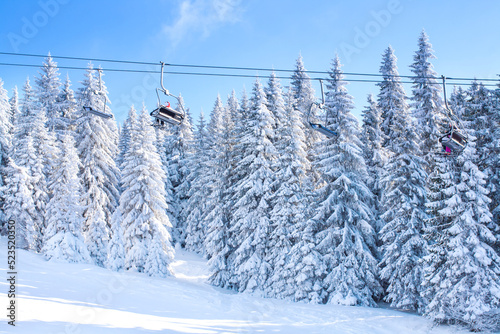 Panorama of ski resort Kopaonik, Serbia, slope, chair lift and trees covered with snow photo