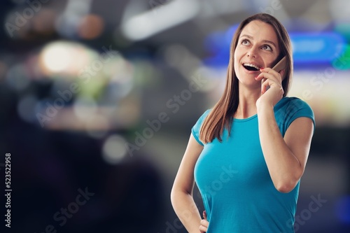 Happy woman holding a smartphone and winning the prize.