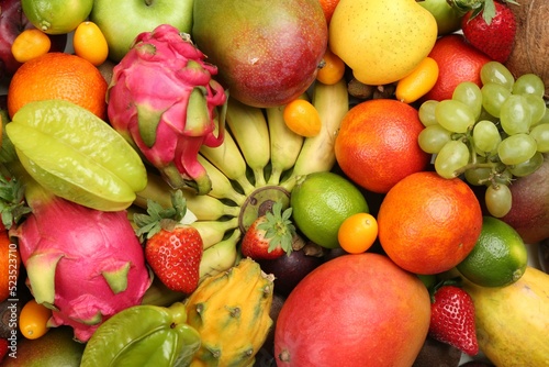 Assortment of fresh exotic fruits as background  top view