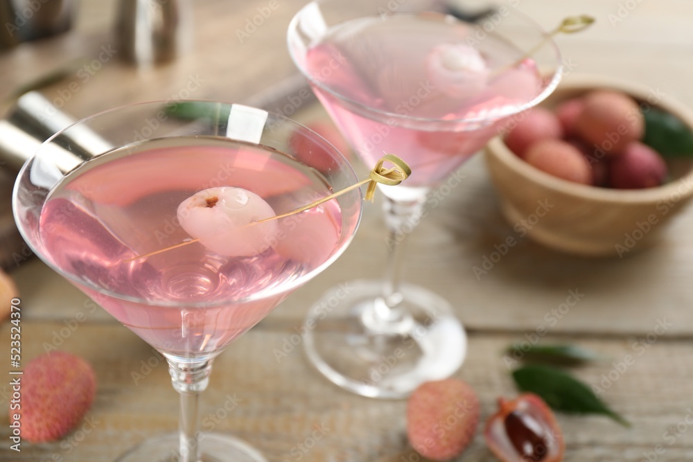Delicious lychee cocktails on wooden table, closeup Delicious lychee cocktails on wooden table, closeup