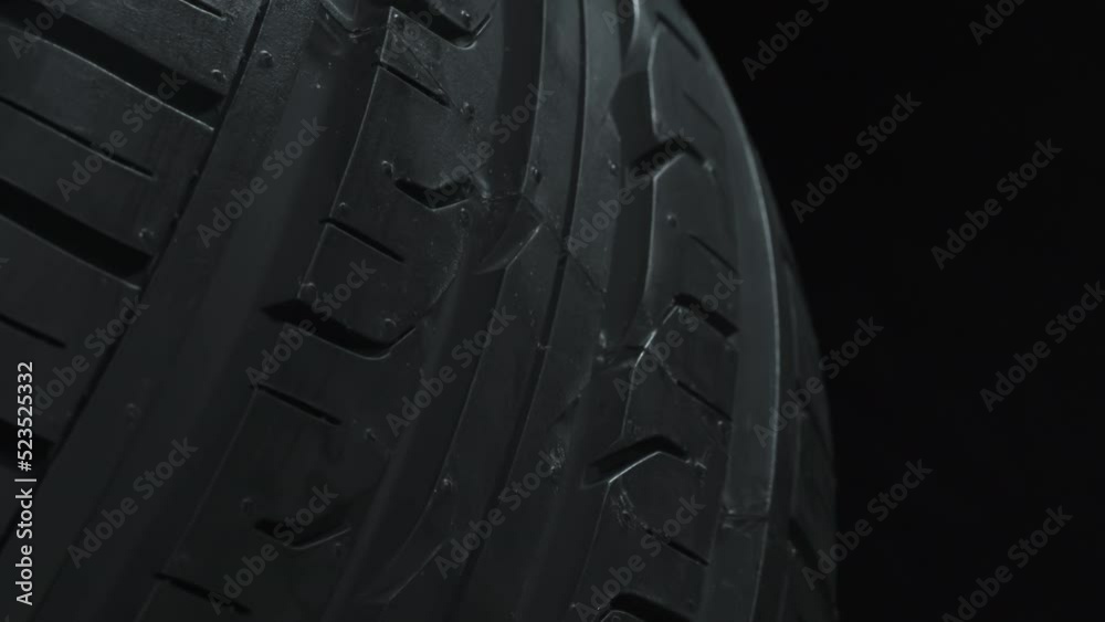 Under the Spinning Car Wheel. The car wheel slowly rotates in front of the camera, which is located at the lowest point, under the wheel