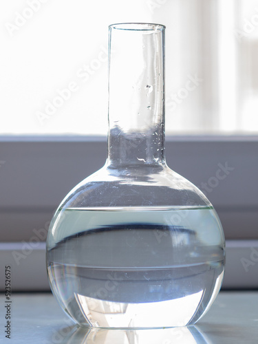 flask with water on the windowsill in the laboratory.