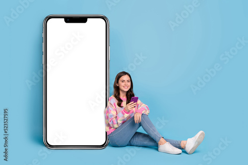 Full size photo of young pretty girl use mobile download share speed connection 4g isolated over blue color background © deagreez