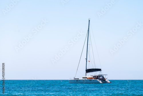 Sailboat at sea on sailing on the waves. Yachtsman during training on a sailboat. © mestock