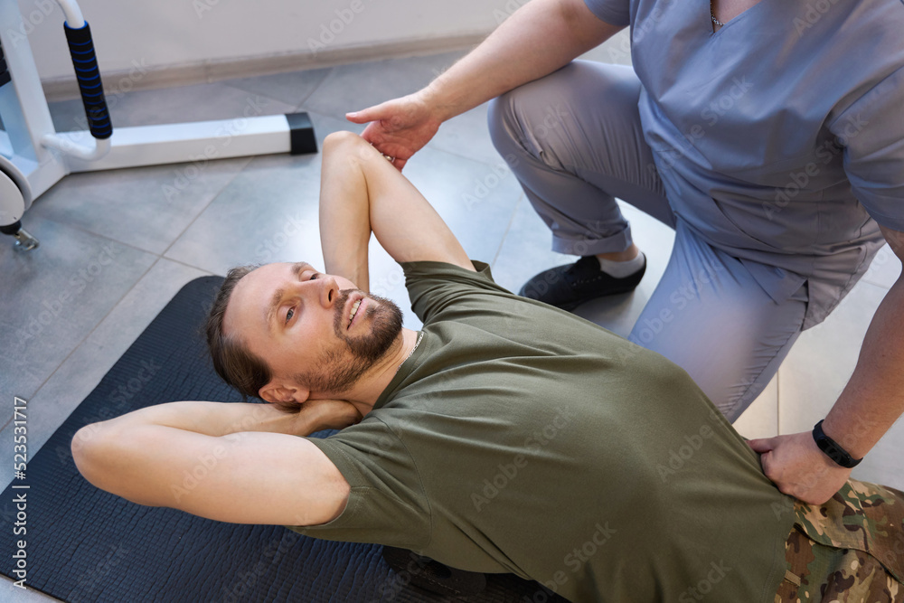 Soldier doing recovery exercises under the supervision of qualified instructor Soldier doing recovery exercises under the supervision of qualified instructor