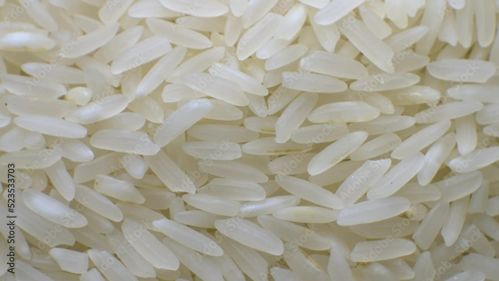 White polished long rice close-up in macro mode rotates in a circle. grocery background high dynamic range White polished long rice close-up in macro mode rotates in a circle. grocery background high dynamic range