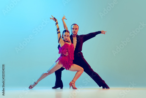 Sticker Beautiful woman and man, professional dancers dancing ballroom dance isolated on blue background