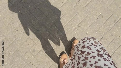 A girl walking on the city, road, stairs.