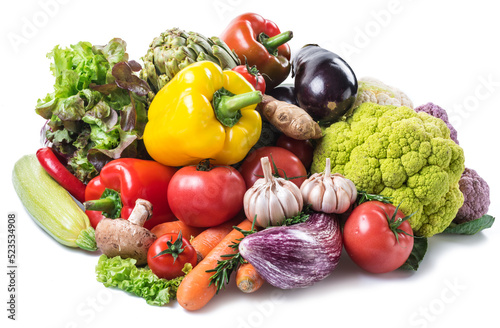 Variety of fresh organic vegetables on white background.