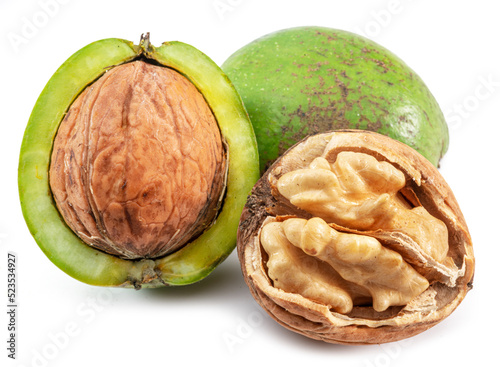 Fresh walnuts in green husk, opened walnut with kernel isolated on white background.