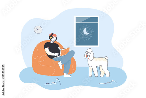 Man in headphones sitting with laptop in bean bag chair. Person and dog spending evening time at home flat vector illustration. Gadget, music concept for banner, website design or landing web page