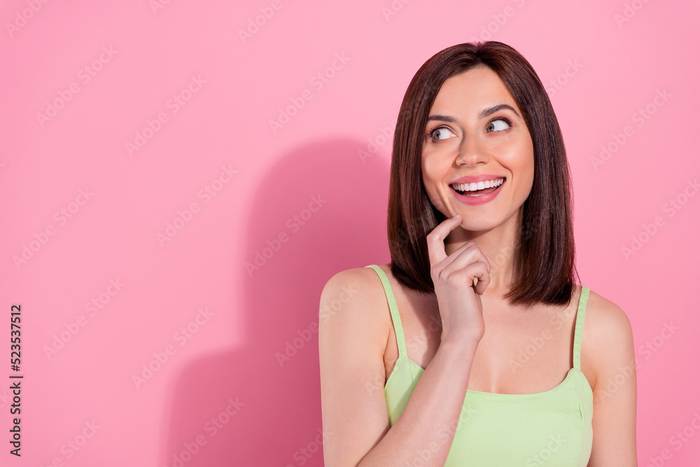 Photo of charming dreamy young lady wear green dress smiling looking empty space isolated pink color background Photo of charming dreamy young lady wear green dress smiling looking empty space isolated pink color background