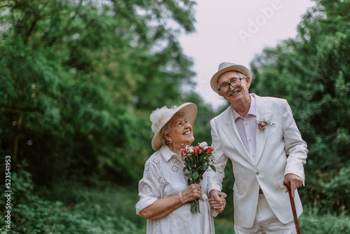 Photos Senior couple having marriage in forest during summer day.