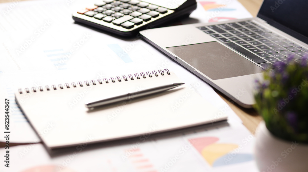 Businessman working on desk and using calculator to calculate business data, accounting documents and laptop in office. Business concept Businessman working on desk and using calculator to calculate business data, accounting documents and laptop in office. Business concept