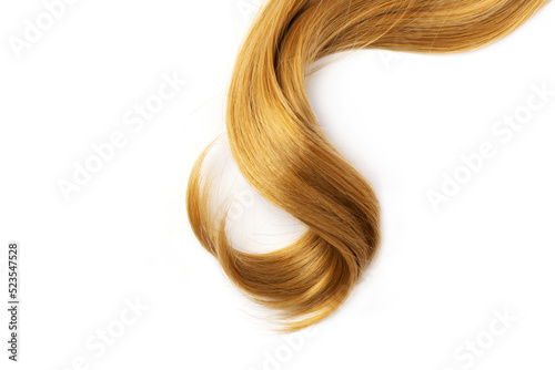 Long golden blond curly hair isolated on white background. A part of blond hair for design.